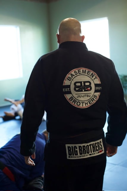 Basement Brothers Jiu Jitsu member with back to camera and logo on gi facing the viewer.
